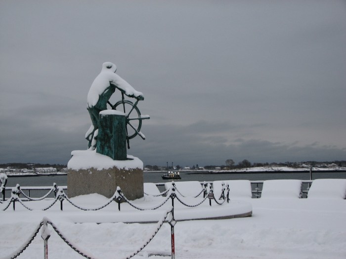 man at wheel snow boat