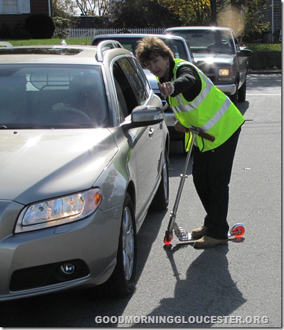 Kathy Middleton directing citizens with her razor scooter