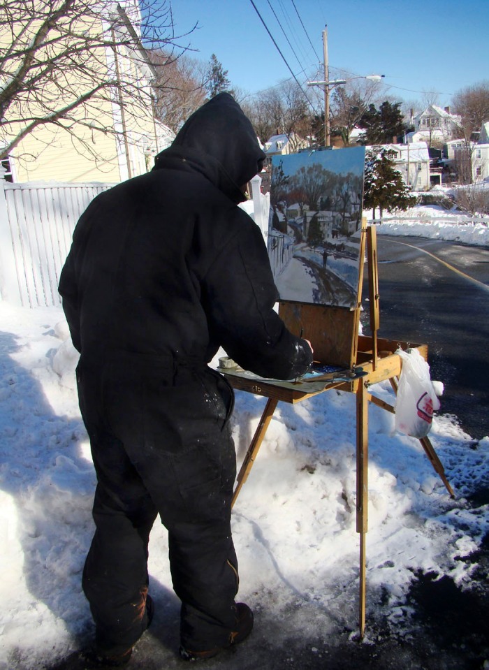photo of painter Chris Coyne painting Annisquam Village En Plein air on a very cold January day
