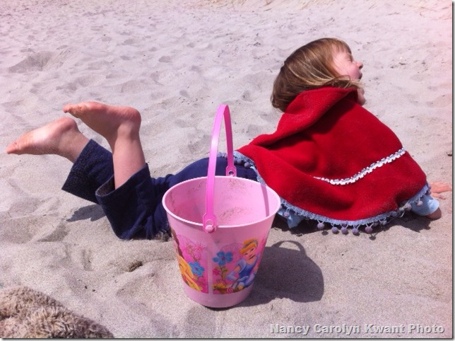 G on beach in poncho