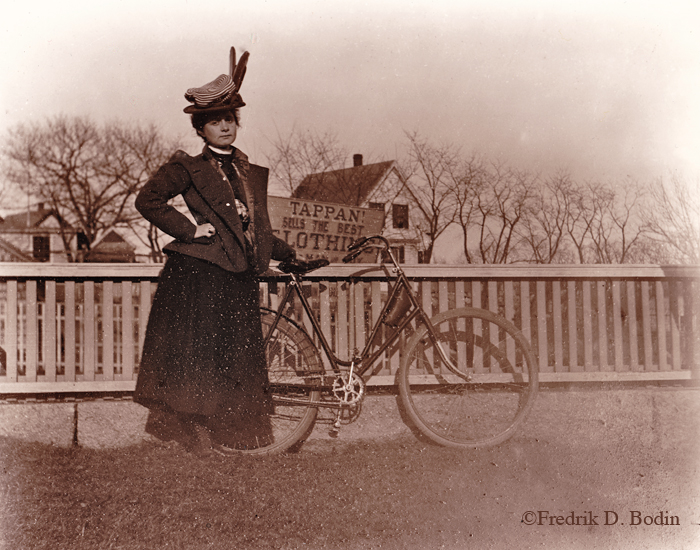Marge Tarr with her bicycle, circa 1900. This is Granite Street in Rockport, MA.