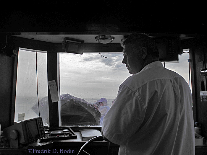 King Eider Captain Steve Douglass brings us thru a rain squall to the Gloucester Schooner Race.