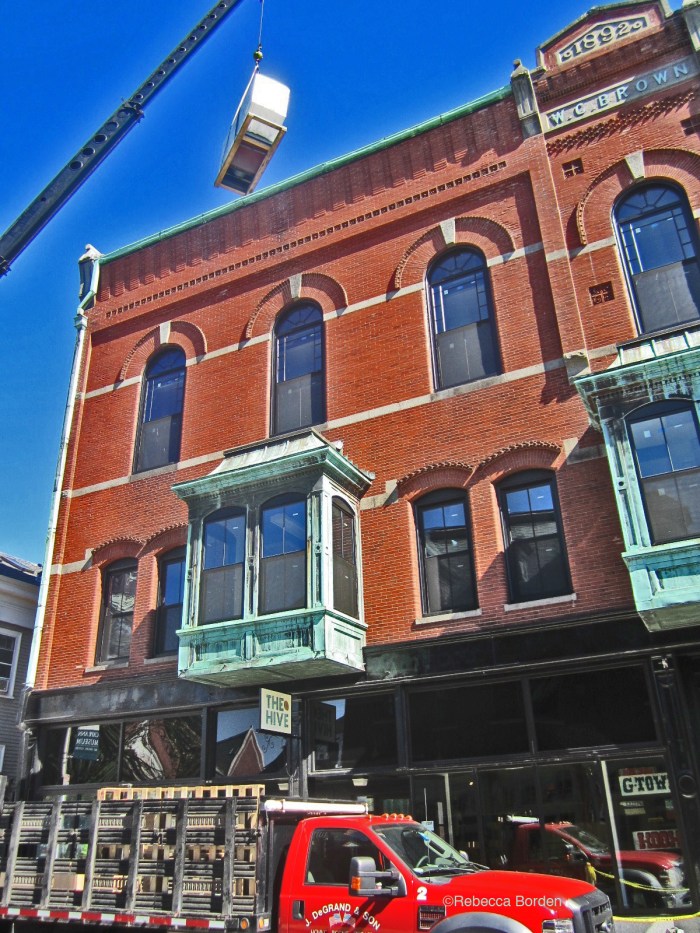 Verizon installing cell tower equipment on the WG Brown building  at the  corner of Main and Pleasant Streets. Photo by Rebecca Borden, President and Interim Executive Director of Art Haven.