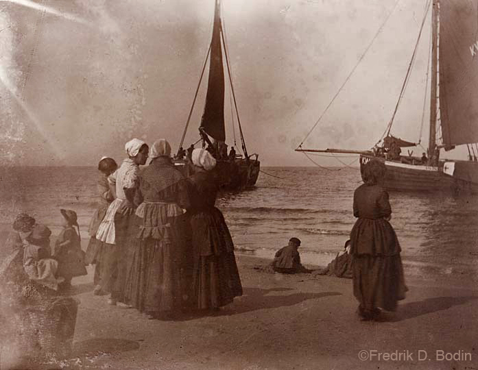 I printed this from a very old glass negative. I think the women and children are there to do more than wave and say welcome home. They'll be transporting the fish to market and home to eat.  Where do you think this is?