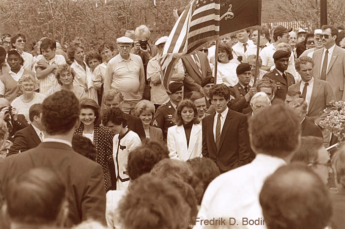 Remembrance of our 35th President, John Fitzgerald Kennedy. On November 22nd, 1963, JFK was assassinated in Dallas, Texas. This is the 50th anniversary of that event, a day which I'll never forget. I was sitting in my 7th grade classroom when the public address system announced that the President had been killed by an assassin. We were sent home in shock immediately. It was a sunny but chilly day as I walked home with a group of my classmates. As we walked along the chain link fence surrounding the school grounds, someone was weeping uncontrollably. It was Peggy Noonan. I didn't know what to do, but tried to console her. Years later I realized she was Catholic, and it affected her, as a 13 year old, on many levels. So we all went to our respective homes, and then the TVs took over. There were no ads for three days, and continuous live coverage, including Lee Harvey Oswald being shot by Jack Ruby amidst law enforcement. I saw that. TV, the media, and all of us will never be the same. If you have a story, share it here my friends. I took this photo at the dedication of the Kennedy School of Government Park on Memorial Drive in Cambridge. L-R in foreground as well as I can tell: Governor Michael Dukakis (partially obscured), Jackie Kennedy, Kitty Dukakis with Ted Kennedy behind her, State Treasurer Martha Coakley (?), Caroline Kennedy, brother John Kennedy, Boston Mayor Kevin White (partially obscured), William Bolger, President of the Massachusetts Senate (partially obscured), and above him is Joe Kennedy.