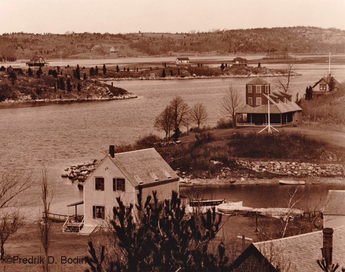 You've seen Trenel Cove on Wolf Hill many times, commuting onto or off of Cape Ann island. The A. Piatt Andrew Bridge (Route 128) connects us with the mainland. It spans the Annisquam River from Rust Island on the left to just beyond the house with the turret on the right (Wolf Hill). Trenel Cove is in the foreground, and was where a small ferry operated. It's now a Gloucester Public Landing (see #11): http://www.gloucester-ma.gov/DocumentCenter/Home/View/426