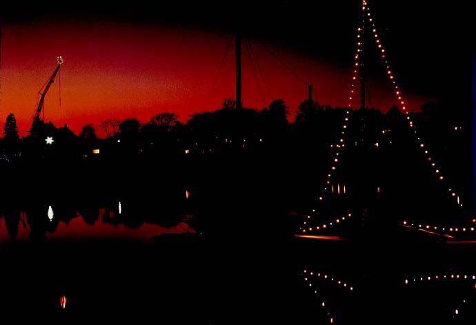Christmas Eve! I took this photo at a Christmas party on East Main Street, looking across Smith Cove. The sailboat was decorated with lights, as was the crane at Bickford's boat yard on Rocky Neck. Co-owner Marco Taormina did that every year. He was a gruff but likable character. He loved to drink his "green grenades," which were bottles of Heineken beer.