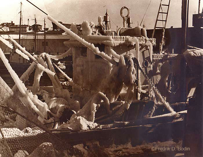 It appears that we'll be out of the arctic's grip in a few days. In this circa 1950 photo, the fishing boat is iced up and cannot go out. Ice can destabilize a vessel to the point of capsizing if not removed. It needs to be removed with sledge hammers and shoveled overboard. The crew, already tired from fishing around the clock, becomes exhausted from ice removal. 