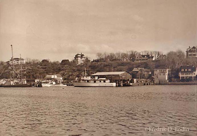 Smith Cove in East Gloucester was, and still is, populated by both fishing and pleasure boats. In the background of the photo is East Main Street, with Banner Hill rising above it. The boats, from left to right: Harpoon sword fishing boat "Jaguar" (previously named Lord Jim and also a WWII submarine chaser), owned by Dr. Fred Breed; "Jumping Jennifer," Tom Morse's fishing boat; Party fishing boat "Winner III," owned by Bobby Anderson; and the "Naomi Bruce III," co-owned by Cy Tysver and the Shoares family. Vessel histories are complex, and all comments and corrections are welcome. 