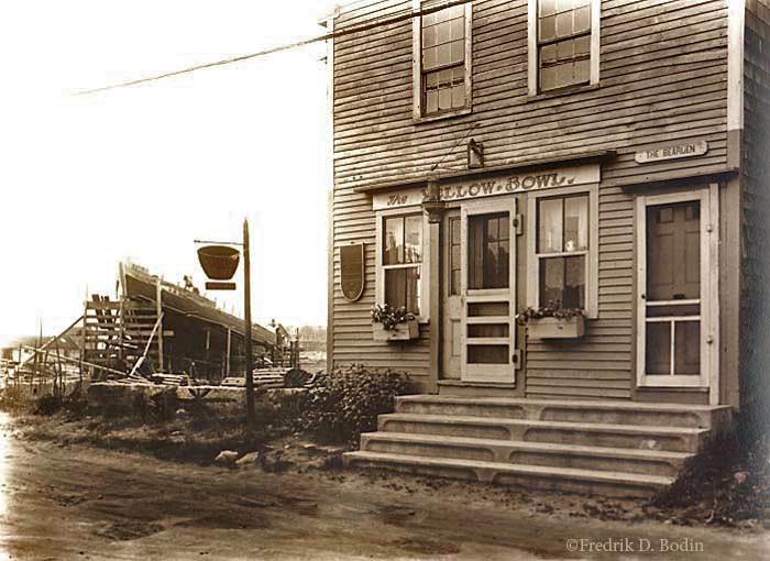 The Yellow Bowl was a tea house on Bearskin Neck. Waddell's shipyard on Bradley Wharf is in the background on the left. The building is still there.