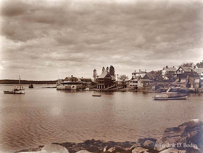 The peninsula called Annisquam is bordered by Ipswich Bay (Atlantic Ocean), the Annisquam River (which makes Gloucester an island), and Lobster Cove. The cove is protected, and therefore a preferred anchorage and mooring area. Judging by the lack of boats in Lobster Cove, this looks to be spring (May 26th to be exact). Annisquam is across the cove, and Wingaersheek is in the distance across the Annisquam River. The geography of Cape Ann is a visual buffet for photographers and painters, and its beauty is here for all to enjoy.