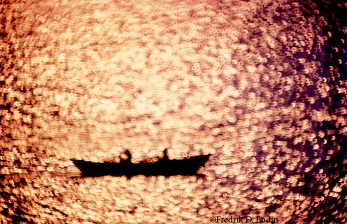 I shot this dory photo with a Nikon 500mm mirror lens. The heavy 500mm beast is known for recording reflected points of light as circles, or "doughnuts." Measuring almost 12 inches long, a tripod is required for sharp photos. Doughnuts do not a great lens make, and I was happy to unload it a couple of years ago. 