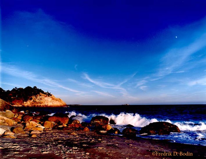 Warm October light enriched the colors and made lengthened the shadows on the beach. The setting sun revealed the moon and a star. This transparency was shot on a tripod with Fuji Velvia film with a Pentax 6x7 (cm) camera. The wide angle 55mm lens accentuated the blue sky. Except for adding my watermark (©Fredrik D. Bodin), no filters or digital manipulation were used.