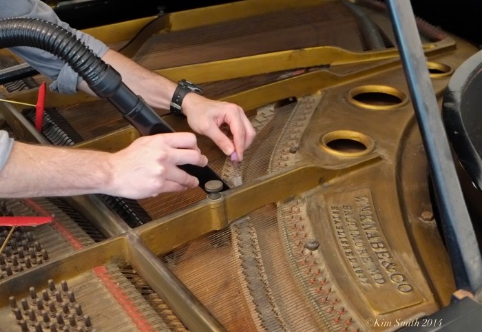 Cleaning inside a piano ©Kim Smith 2014