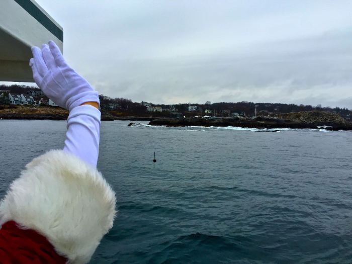 Santa Warming up his waving by greeting the Homies roosting out on Sandy Bay Ledge.