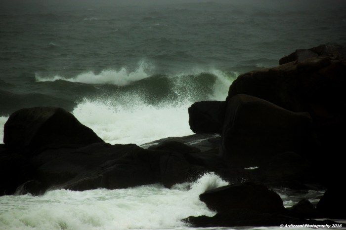 March 15, 2016 dark rocks white surf on a rainy day