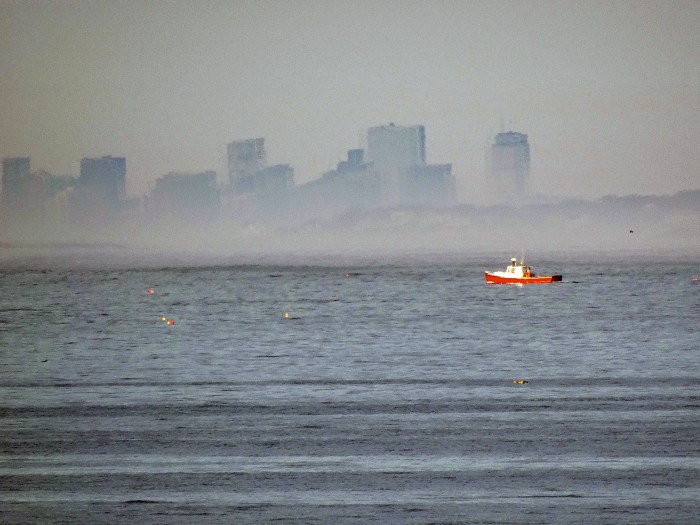red boat and boston skyline