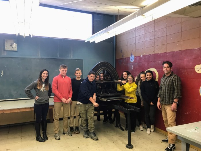 teachers Brett Dunton and Ashley Doke with 8th grade students admiring the newly installed famous Acorn press O'Maley Innovation Middle School, Gloucester MA