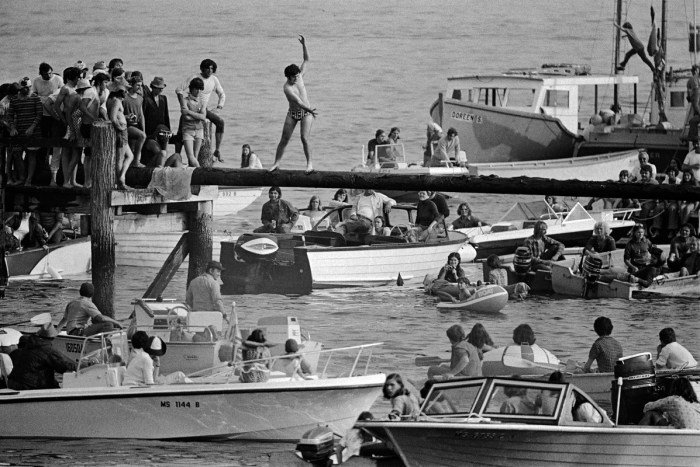 4th of july greased pole walk over water glouceter ma by 1973 by Spencer Grant