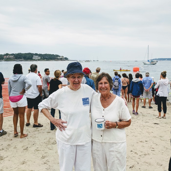 Sarah Robbins Evans on the right with Barbara Blais watching 40th Anniversary Celebrate Clean Harbor Swim_Evans co founder both swam it many years _20180811_©c ryan Gloucester Mass