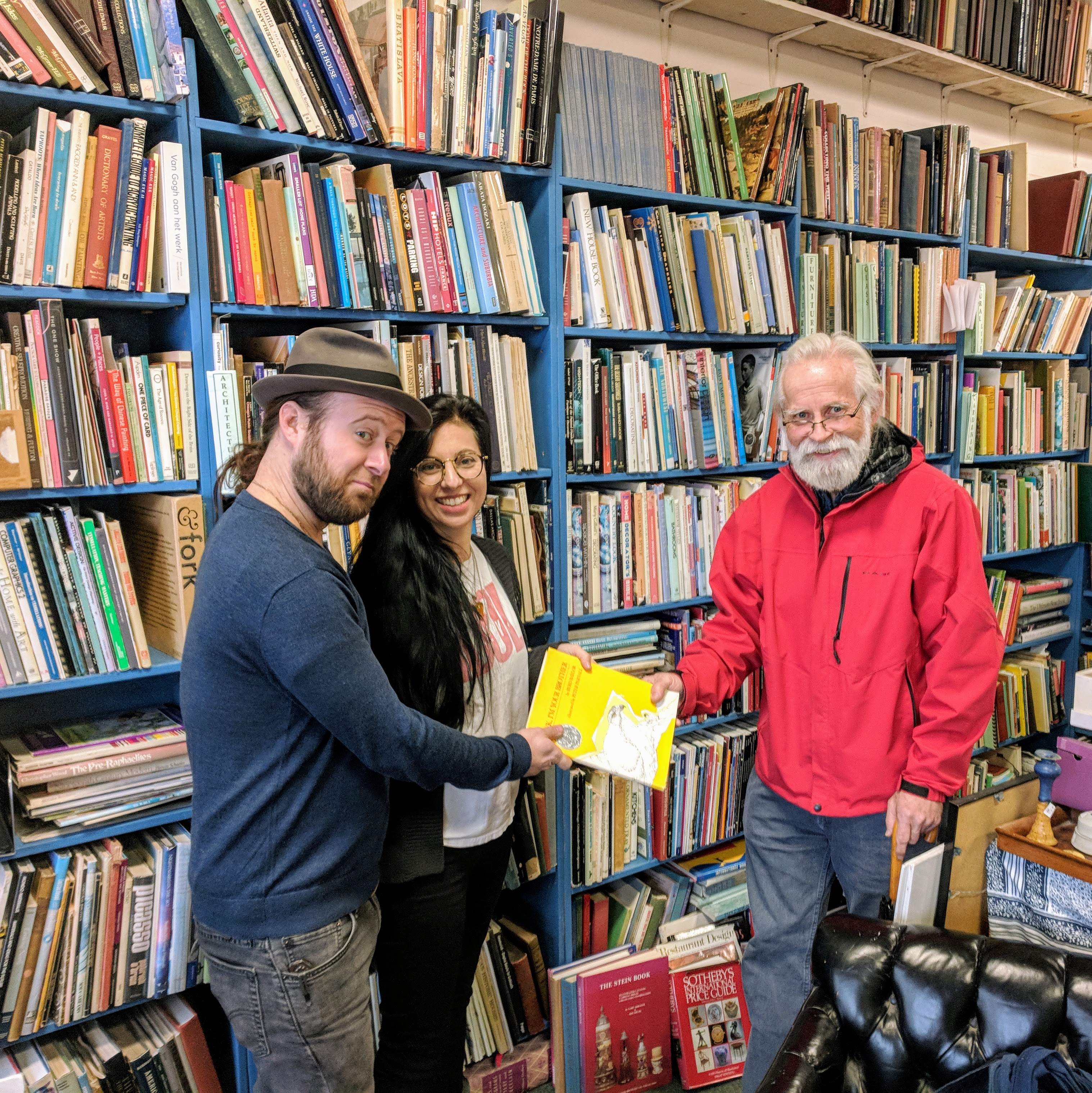 Passing the torch _portrait of BOB RITCHIE_used and rare books dealer_on his last day at Dogtown Books_with new owners_Lucas Cotterman_Caroline Harvey_Gloucester Ma_20181119_© c ryan.jpg