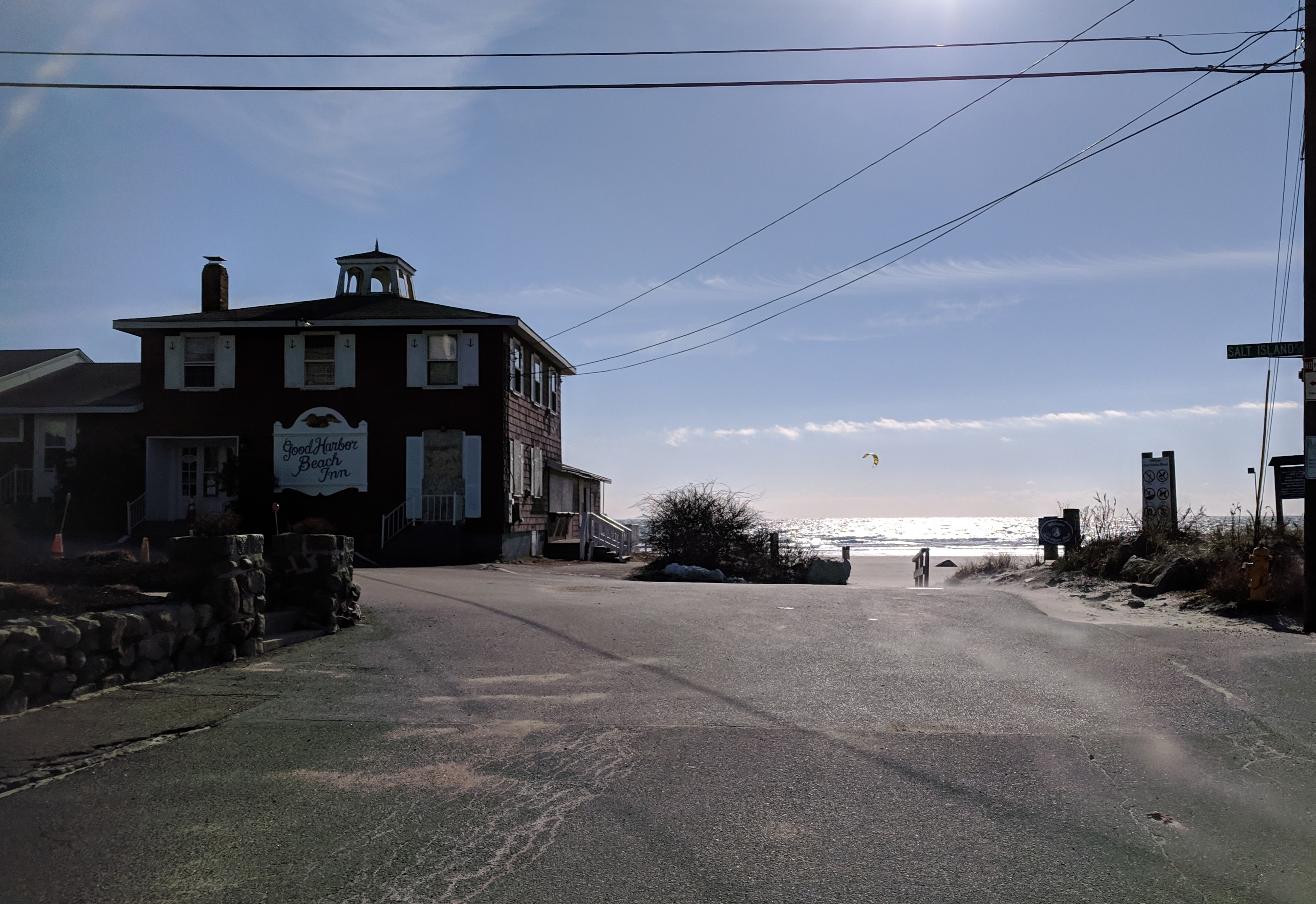distinct sail shapes visible by good harbor beach motor inn and across marsh before one reaches ocean_20190127_kitesurfing jan 27 2019 gloucester mass © catherine ryan