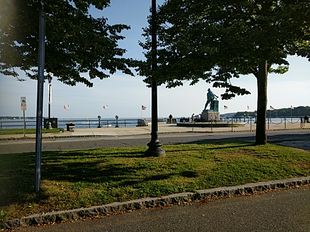 Leonard Craske man at wheel memorial looking out to Gloucester Harbor.gif