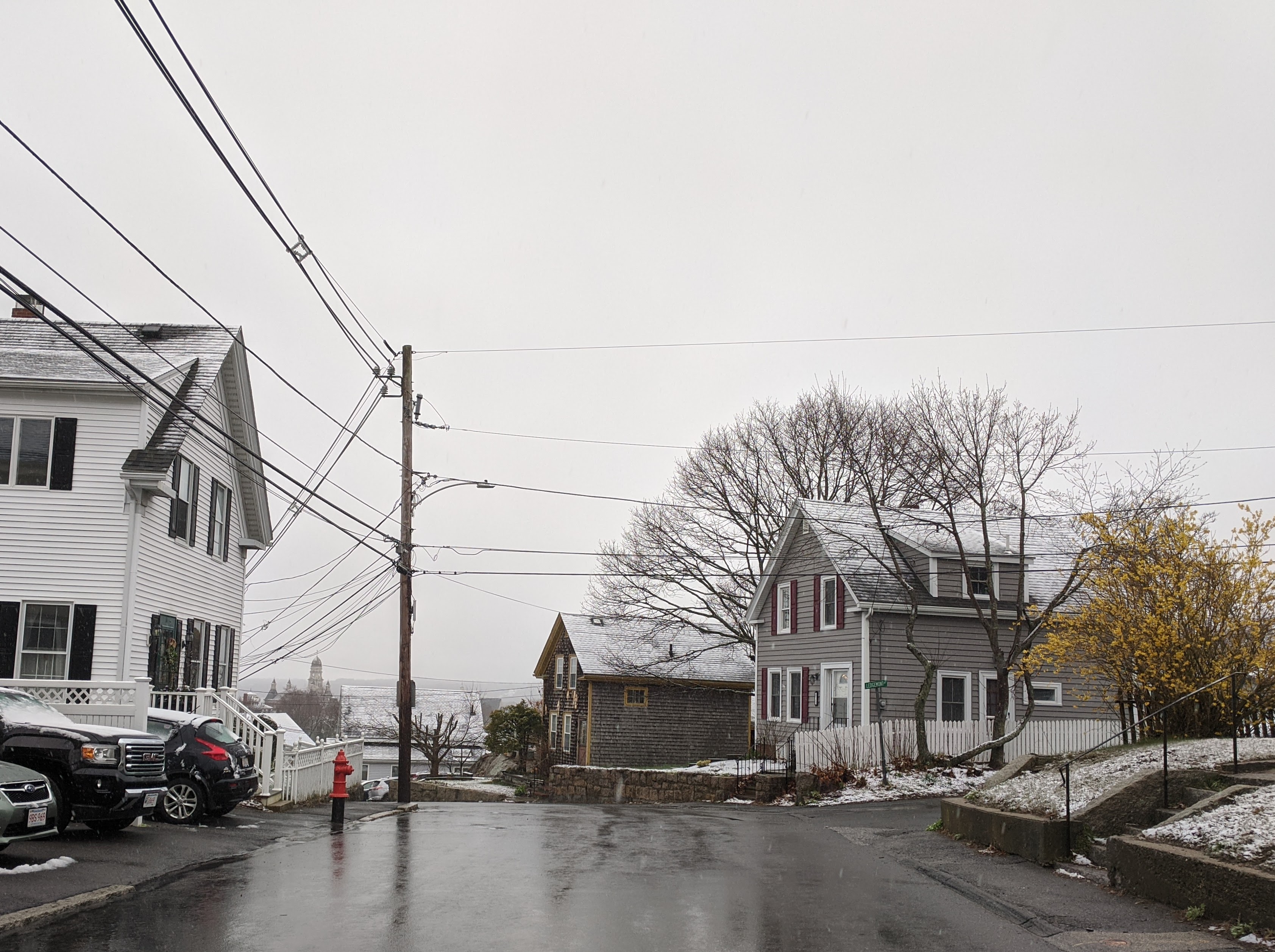 spring snow light dusting on rooftops_view to city hall gloucester Ma_20200418_©c ryan