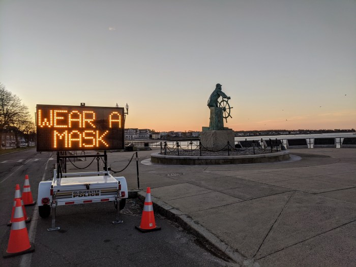WEAR A MASK_Man at Wheel memorial_Signs of the times_Gloucester Mass., 6 May 2020, covid-19 © c ryan